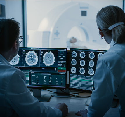 innovation-img-2 Patient in MRI Scanner and Doctors reviewing brain activity