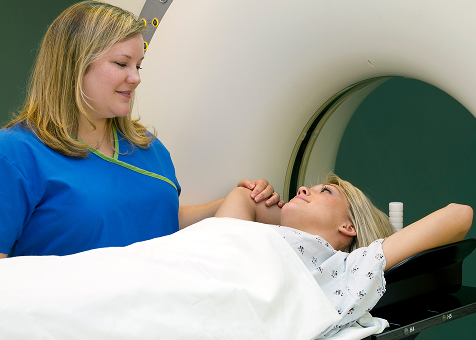 Nurse helping patient go into MRI scanner