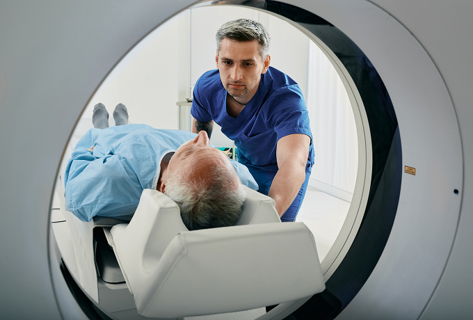Nurse helping patient go into MRI scanner